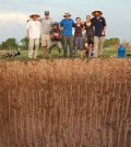 Earth system scientist Scott Fendorf (white shirt) poses with his team above a seasonal wetland that was dug out and flooded to simulate a permanent wetland environment. (Credit: Scott Fendorf / Stanford University)