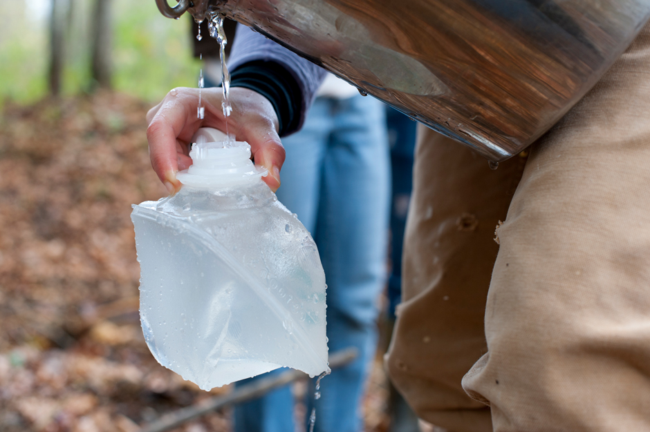 Filling a sample bottle for laboratory analysis in Raccoon Creek Watershed