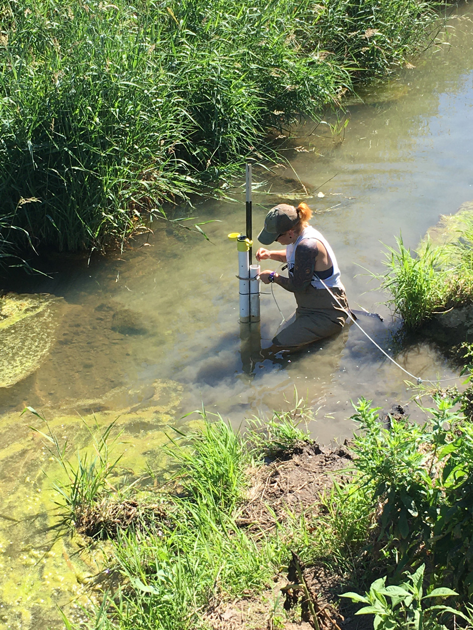 Student installing a HOBO data logger in an agricultural stream in Licking County, Ohio.