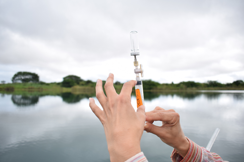 Marcia Macedo, a scientist at the Woodwell Climate Research Center, transfers a gas sample collected from a reservoir to a preevacuated vial for later laboratory analysis. She has collected thousands of samples from dozens of reservoirs in the southeastern Amazon to help understand the impact of these water bodies on greenhouse gas (methane and carbon dioxide) emissions from the region.