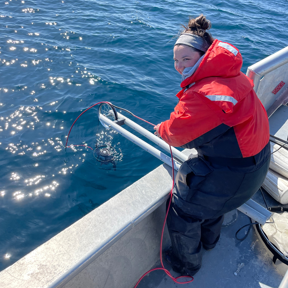 PhD candidate Nicole Berry measures water transparency using an underwater radiometer. The offshore regions of Lakes Michigan and Huron are increasing in water transparency. This may expose the early life stages of fish to damaging ultraviolet radiation.