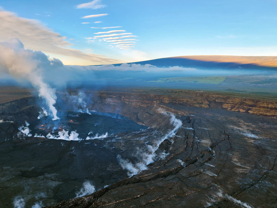 During a Kīlauea summit morning monitoring overflight on February 2, 2023, HVO scientists documented activity in the ongoing Halema‘uma‘u eruption, shown in this photo looking to the SW at 7:30 a.m. HST. Mauna Loa is visible in the background.