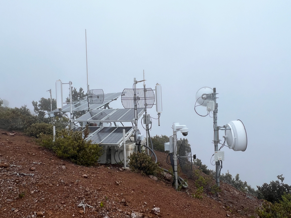 During the week of April 10, Hawaiian Volcano Observatory technicians upgraded the Hualālai repeater site, which is an important telemetry hub for volcano monitoring data. The site is located on the southeast side of Hualālai, at an elevation of 2,160 meters (7,090 feet) above sea level. This photo, taken after the upgrades were completed, shows the site enshrouded in fog. Upgrades included replacing the batteries, installing a new electronics system and box, and installing a new webcam looking at Mauna Loa. The station upgrades and new webcam were funded by the USGS Additional Supplemental Appropriations for Disaster Relief Act of 2019. 