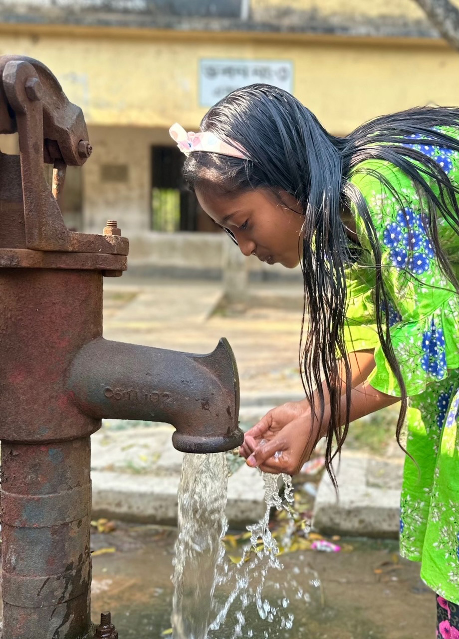 A pupil drinks from the Teriail school well. The well is located in the school’s courtyard, and is used by students for drinking and washing. 