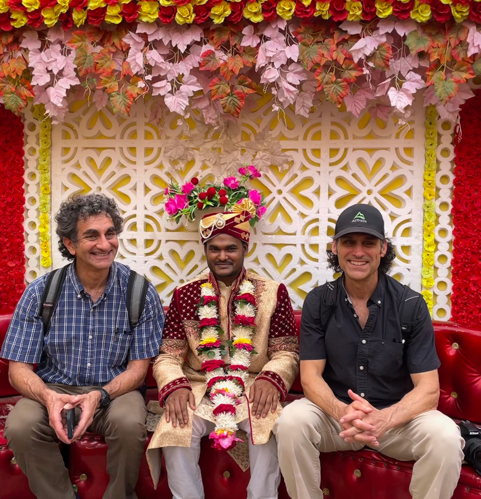 Matthew Karanian (left) and Robert Kurkjian (right) sit beside a man who is celebrating his wedding in the community of Teriail. 