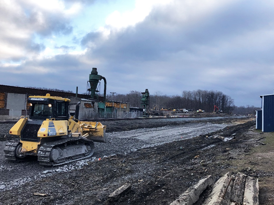 A cleared area of the south track is backfilled with clean material and graded.