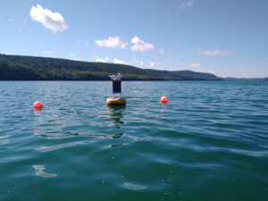 Data buoy in seemingly clean water, but the white foamy scum on the water surface contained high concentrations of cyanobacteria (MIcrocystis aeruginosa), a tell-tale indicator or harmful algal blooms.