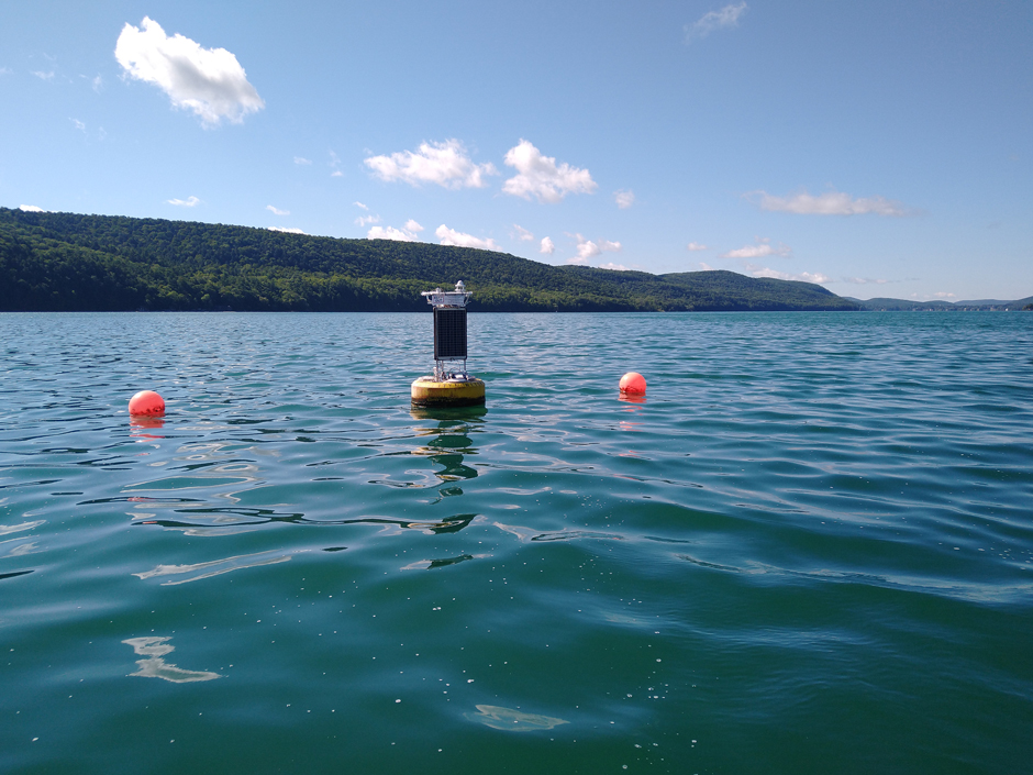 Data buoy in seemingly clean water, but the white foamy scum on the water surface contained high concentrations of cyanobacteria (MIcrocystis aeruginosa), a tell-tale indicator or harmful algal blooms.