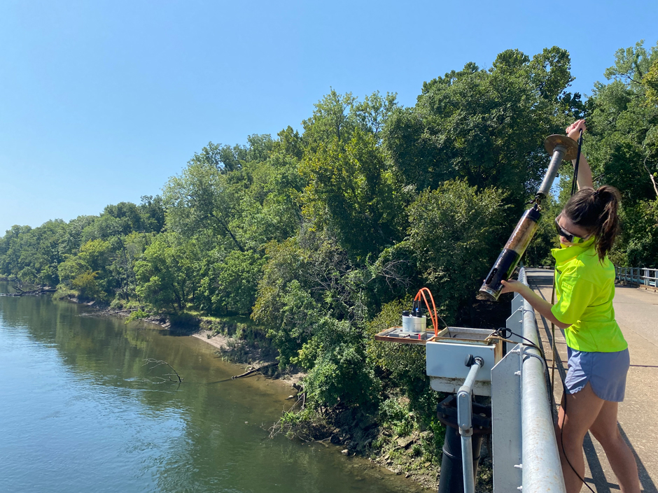 An OWRB staff member pulls a multiparameter sonde out of a drag tube attached to Langley Bridge downstream of Pensacola Dam on Grand Lake. 