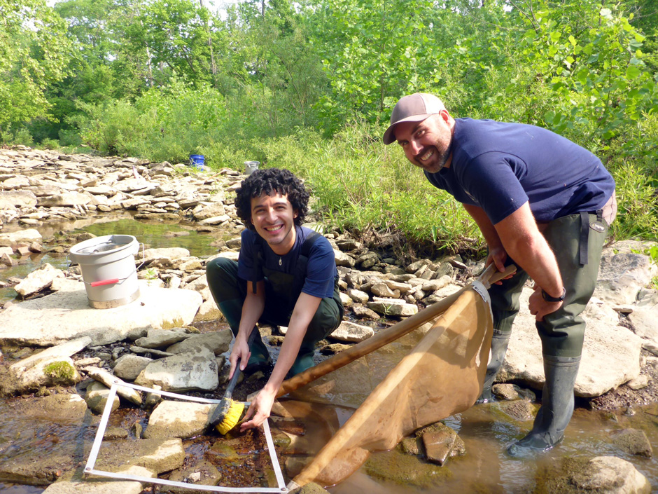 Intern Matteo Ortiz sampling macroinvertebrates in an Ohio River tributary.