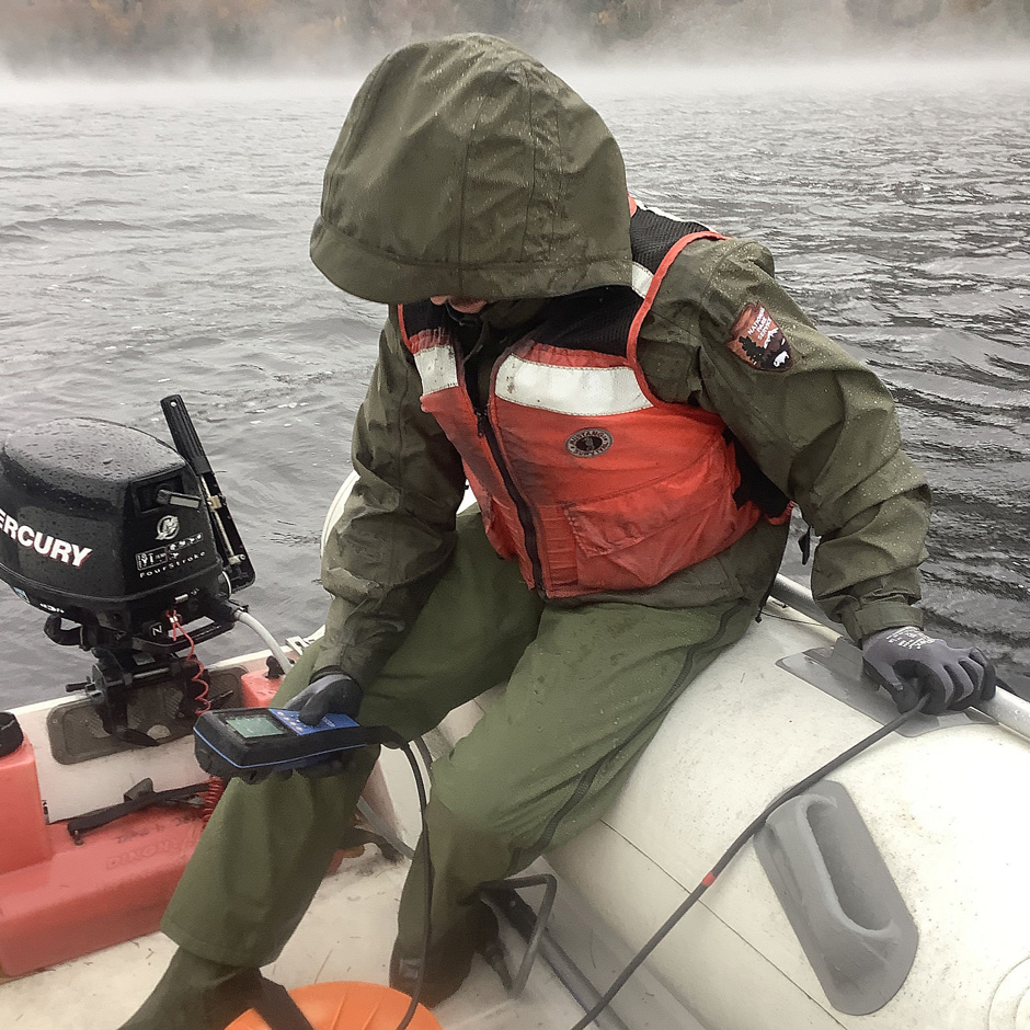 : Acadia NP Biological Technician Jake Van Gorder collects a water quality data profile using a YSI EXO1 sonde during a monthly lake monitoring visit.