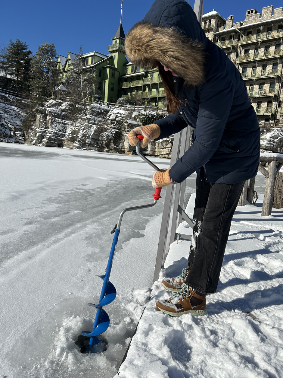 Delaney Long (Biology '24) is drilling a hole in the ice at Mohonk Lake with the Mohonk Mountain House in the background. She is checking the thickness of the ice: the ice was ~7cm (<3inches) thick at this location but there was open water at the south end of the lake despite the frigid temperatures. 