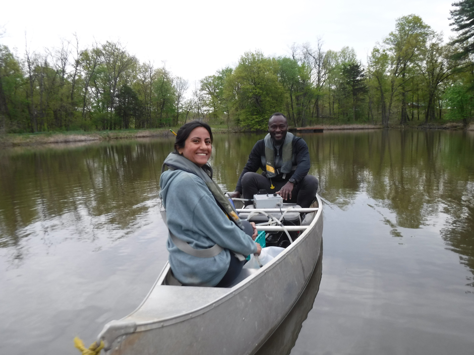Water Resources graduate students- Fatima Laraib and Yusuf Olaleye- conduct a thiamine addition experiment on Crow Pond, Prairie Fork Conservation Area, Missouri.