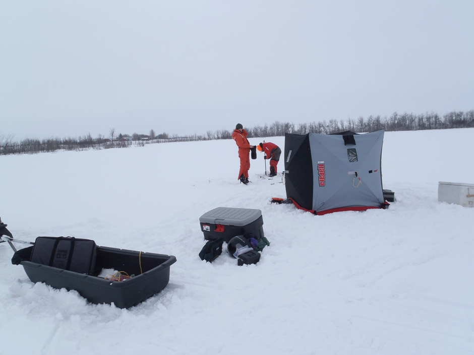 Global Institute for Water Security, University of Saskatchewan staff- Sheena McInnes and Heather Wilson- conduct winter limnology on a Saskatchewan reservoir, Canada at -30 degrees Celsius