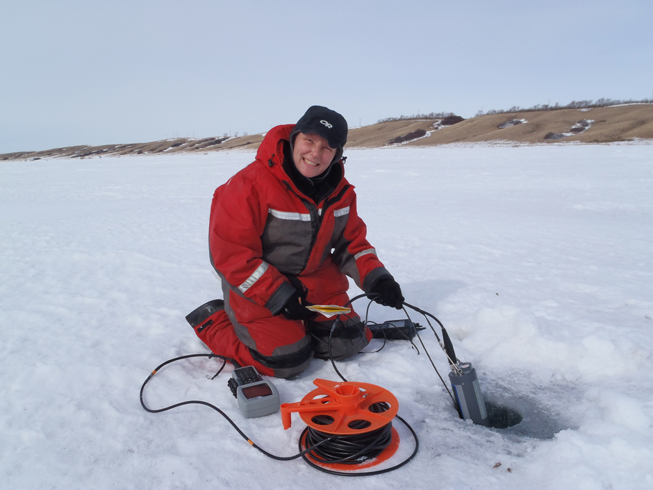 YSIRebeccaNorth: Rebecca North takes a YSI sonde profile through the ice on Lake Diefenbaker, Saskatchewan, Canada. 