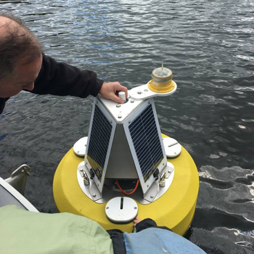 FOTL member Scott Conant steadies the buoy.