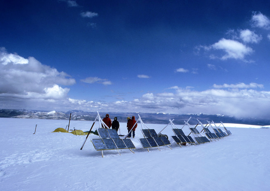 Thompson and his team observing the solar panels charging the ice-core drill on top of the Quelccaya Glacier in Peru 1983. 