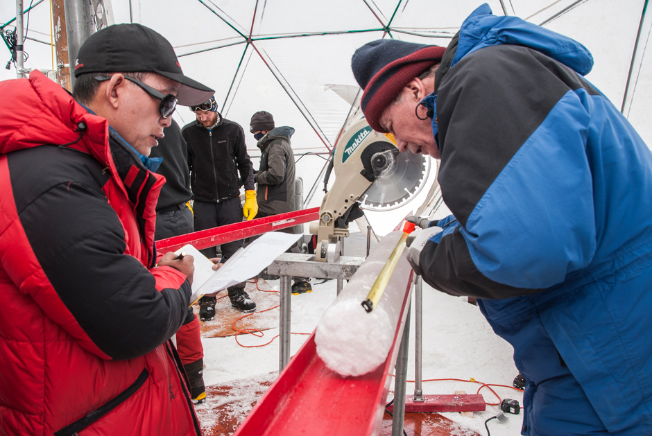 Thompson (right) and a colleague processing an ice core from the Guliya ice cap in the Western Kunlun Mountains, Tibet.