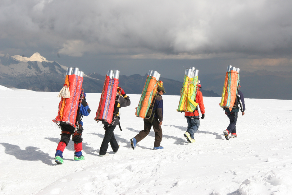 Porters must carry the ice cores down from the drill site after the drilling is finished.