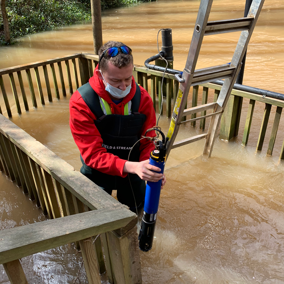 WKU Graduate Student JT Troxell checking an EXO II during a flood event. 