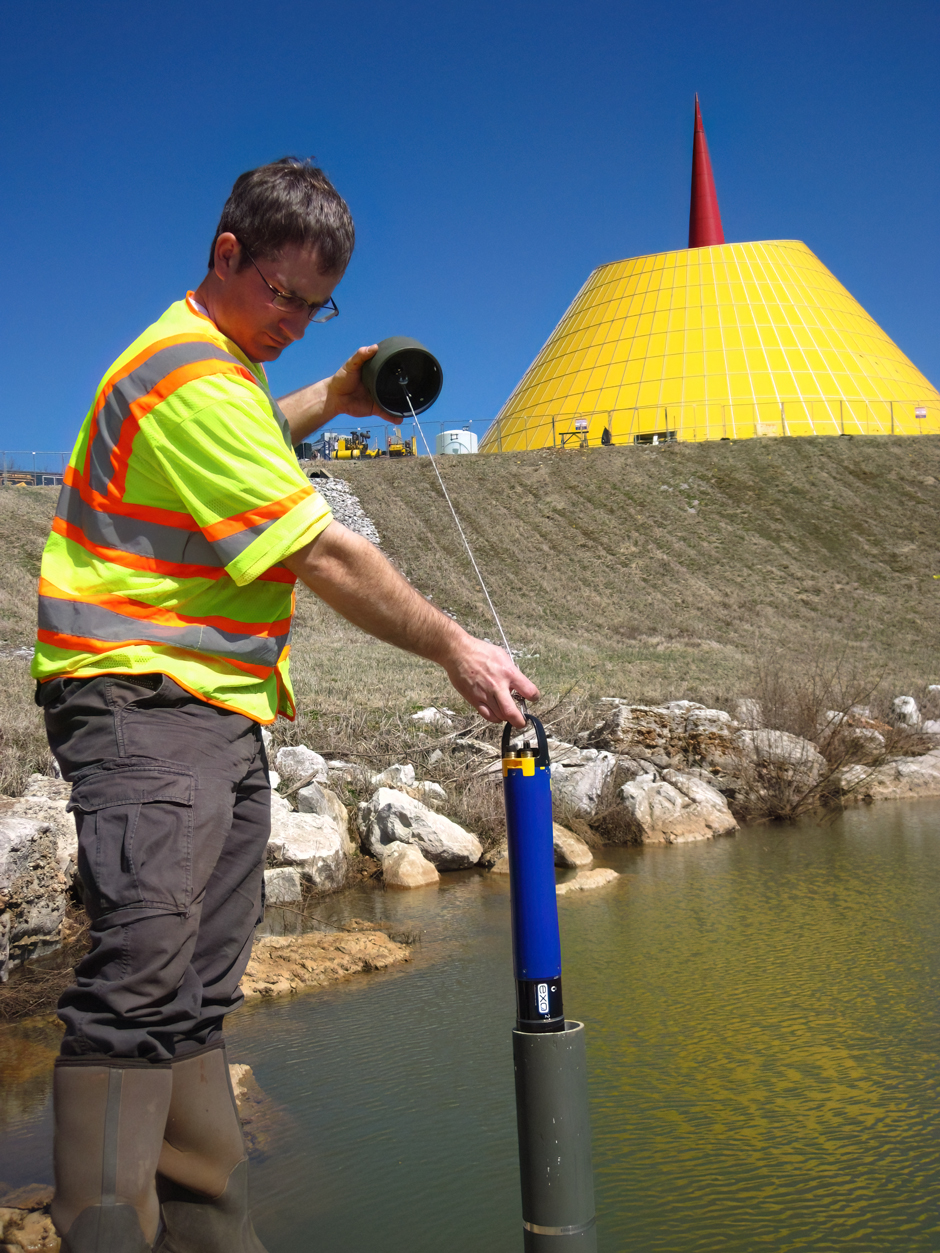 WKU CHNGES Graduate Student Dan Nedvidek deploying a sonde to monitor at the National Corvette Museum sinkhole project.