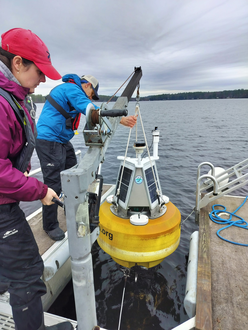 Ben Peierls and Maggie Welch prepare to release buoy on Highland Lake