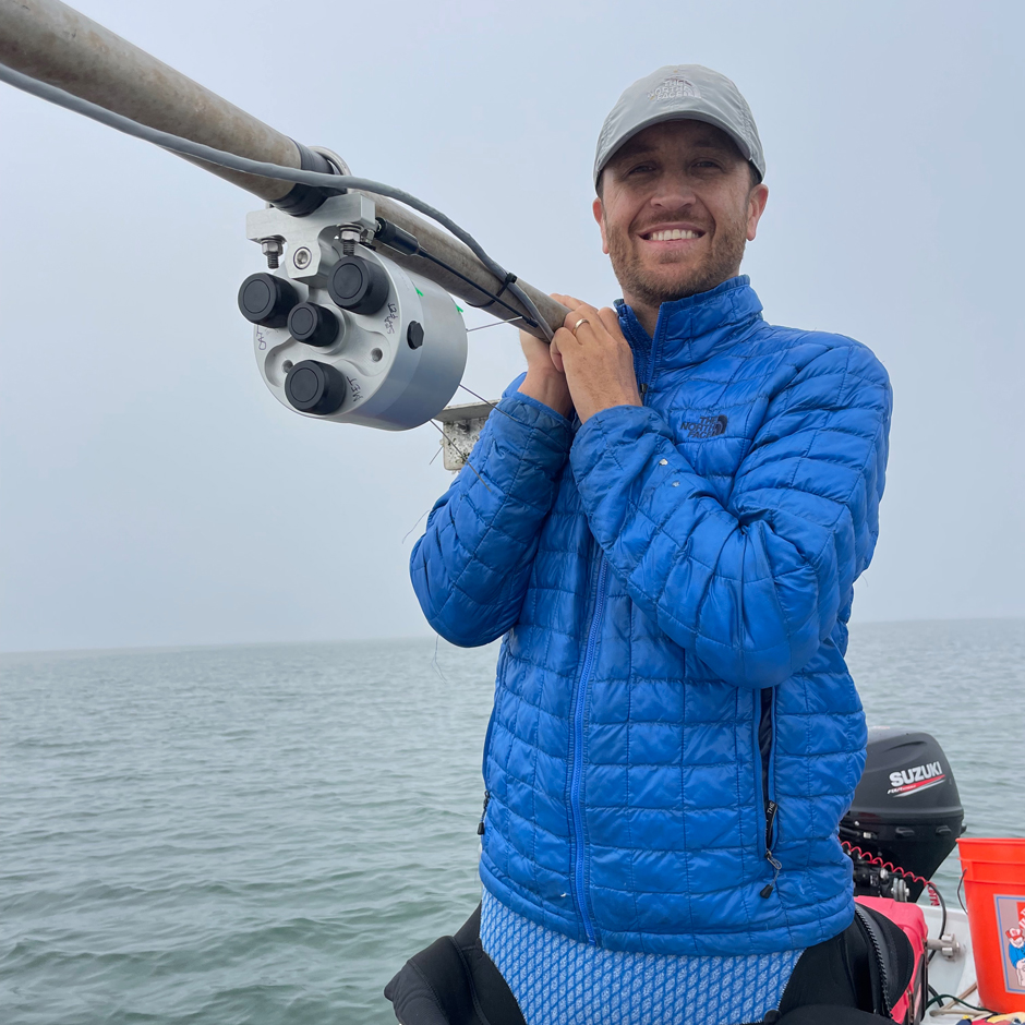 Dr Ryan Walter holds the top-side pole at BS1, preparing to connect the Seabird HydroCAT, SeaFET, and Gill weather station to the NexSens datalogger for the initial deployment . 