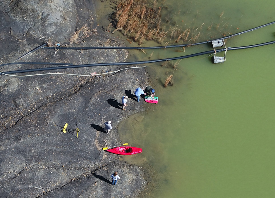 DOW bathymetry team assisting Abandoned Mine Lands in collecting depth /volume data at a coal pond retention basin. the image is taken from above using a drone