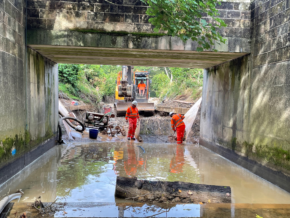 Two workers helping to remove the Snake Lane Weir and restore the freshwater habitats above and below the weir.