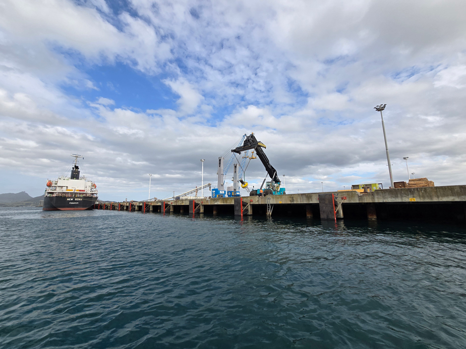 A crane lifts a buoy into the water as the first stage of deployment begins.
