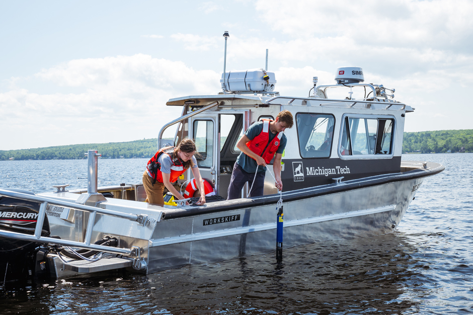 Two Great Lakes Research Center staff members sampling water quality using a YSI EXO2 in the Portage Waterway, which connects to Lake Superior on both ends. 
