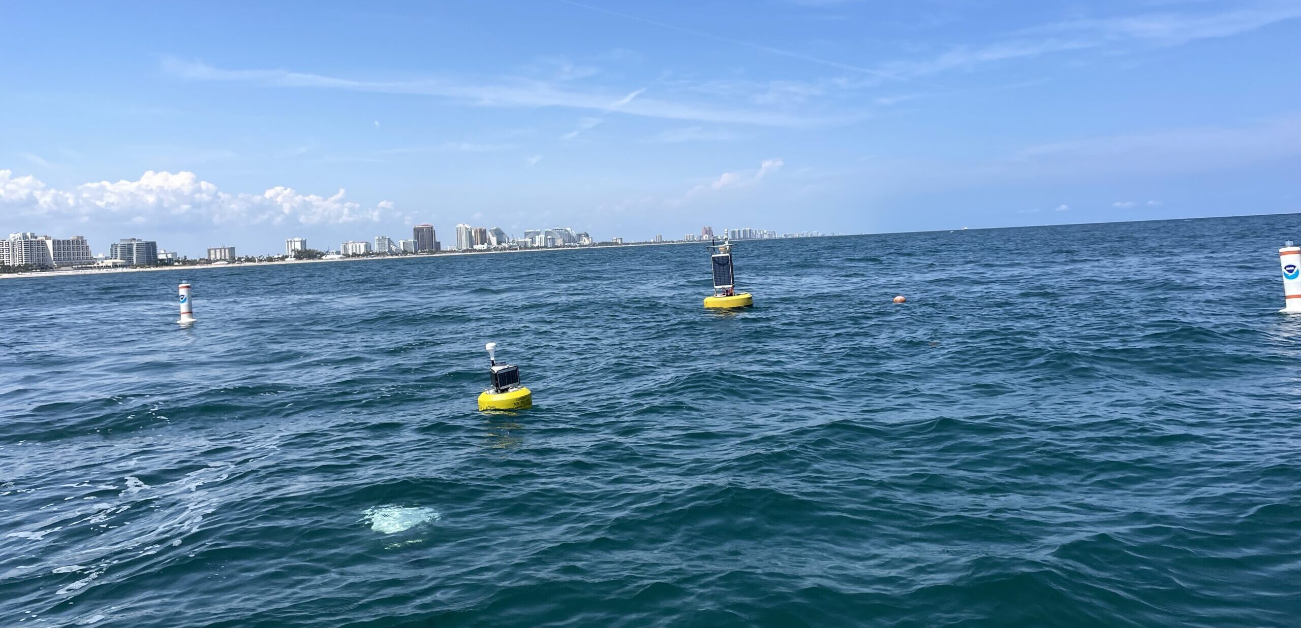A CB-950 and CB-25 deployed on site at Port Everglades. The sensor buoys are protected by white buoys on the sides to prevent collisions with boats in the area.