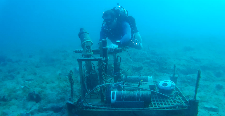 Divers are servicing the bottom package by cleaning the sensors and checking their functionality.