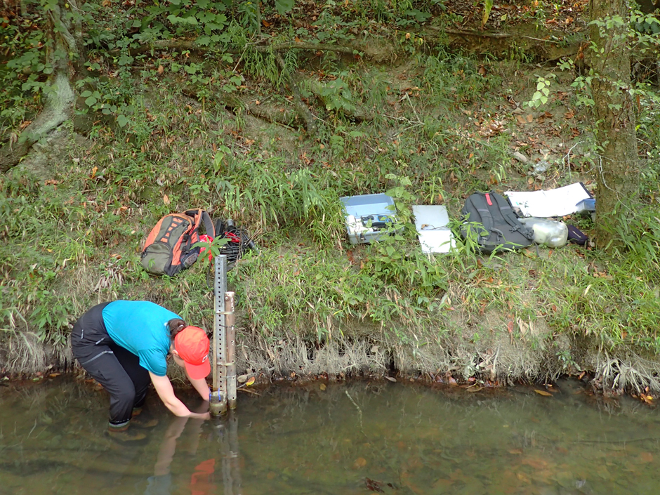 Annie Blalock, a research technician at the University of Georgia, checking on sensors in Holly Creek.
