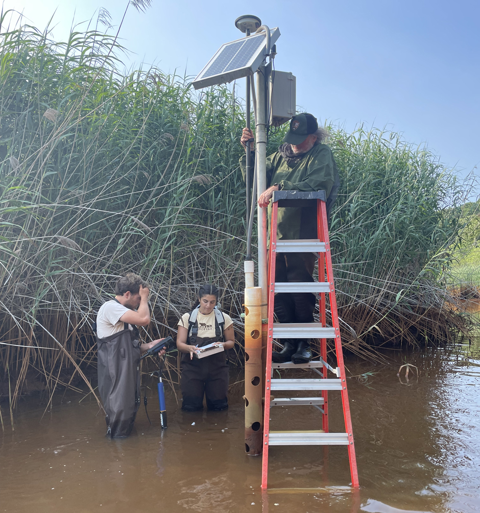 The team conducts an elevation survey at one of the real-time monitoring stations.