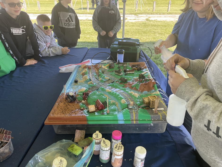PCS Staff engaging middle schoolers from Delta, OH in a wetland and waterway connectivity activity at Delta Water Celebration Day 2024.