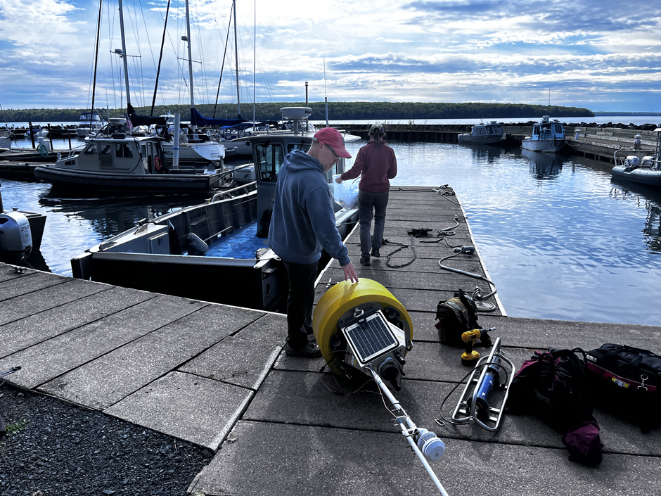 Research technician Jeffrey Neuse looks over the Mawikwe Panther Buoy prior to deployment in Lake Superior.