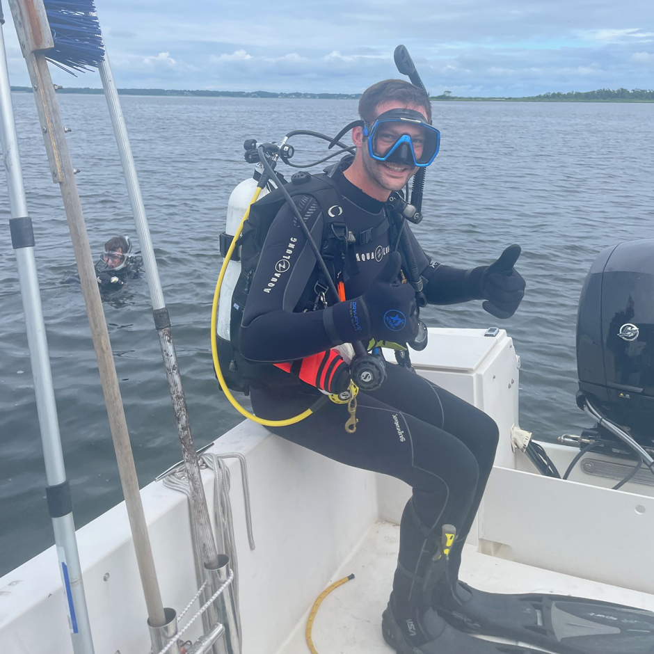 Mike Potter (on boat), Vinny Deingeniis (URI-graduate student) diving on North Prudence buoy for inspection during summer 2024.