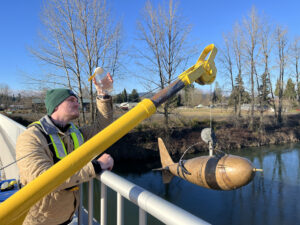 Luke Travis collecting sediment samples from the Cowlitz River near Castle Rock, WA, during a training.