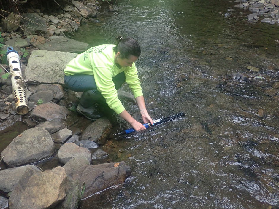 Elk County Conservation District Watershed Technician, Micaela, is rinsing the sonde to remove any silt buildup prior to cleaning and calibration.