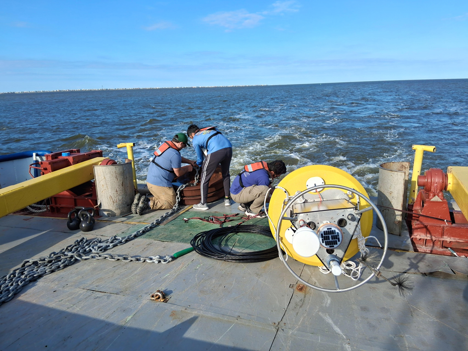 University of South Alabama graduate student, Aravind Puzhankara, and Dauphin Island Sea Lab technician, AJ Stewart, securing the anchor chain on the way out to the deployment site.