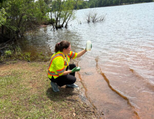 Emily Larrimore responding to a customer request reporting scum on the lake.
