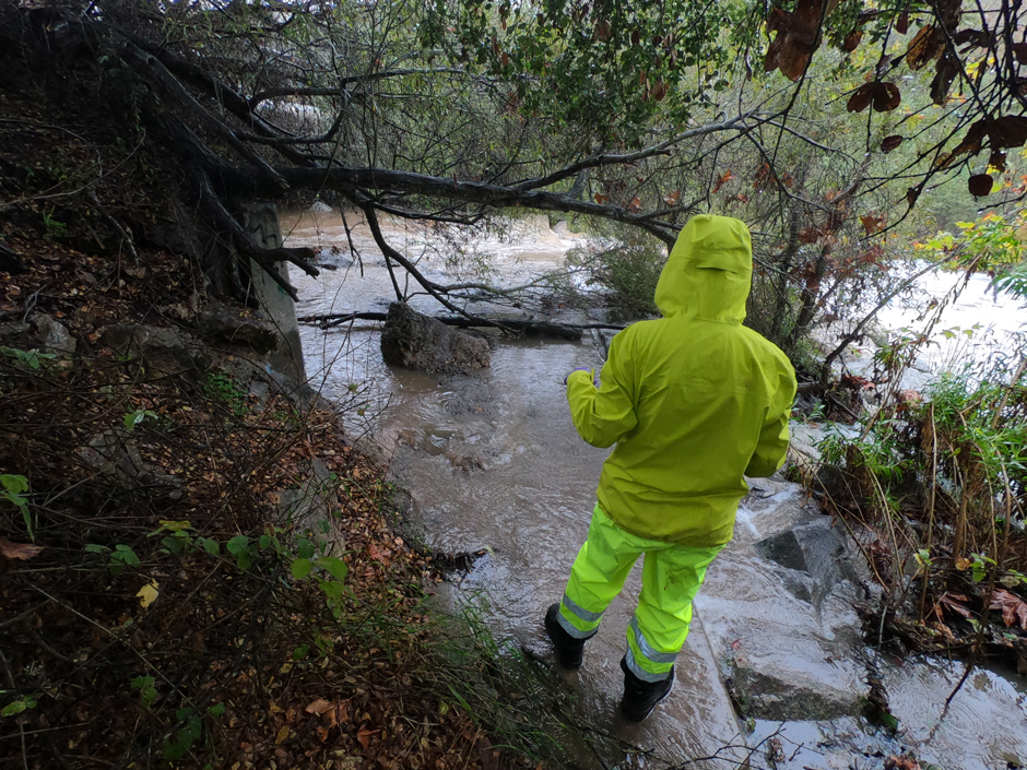 Shepherd is seen sampling from Arroyo Burro Creek’s bank at Cliff Drive during a rain event, as the creek is flooded in the area she normally takes samples from.