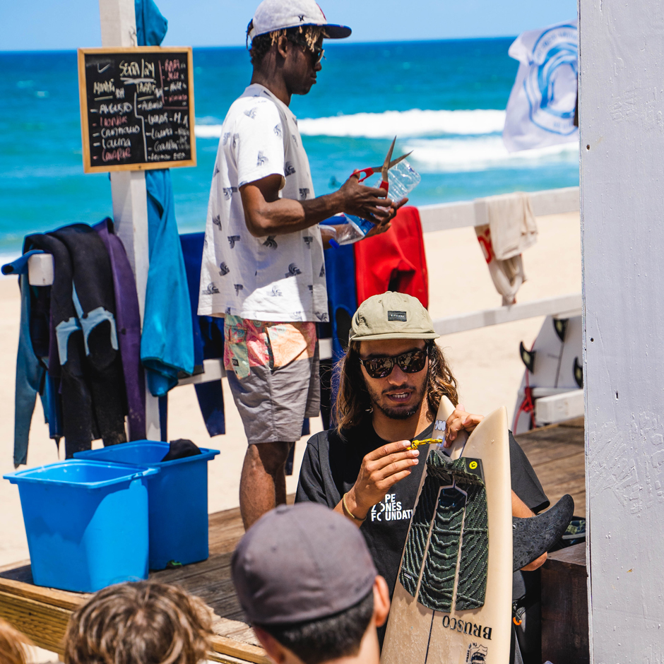 Pro Surfers Jeje Vidal (white shirt) and Miguel Blanco (with surfboard) explain the importance of recycling and waste management for the ocean in general and Marine Protected Areas in particular at Hope Zones Praia Grande, Sintra HQ.