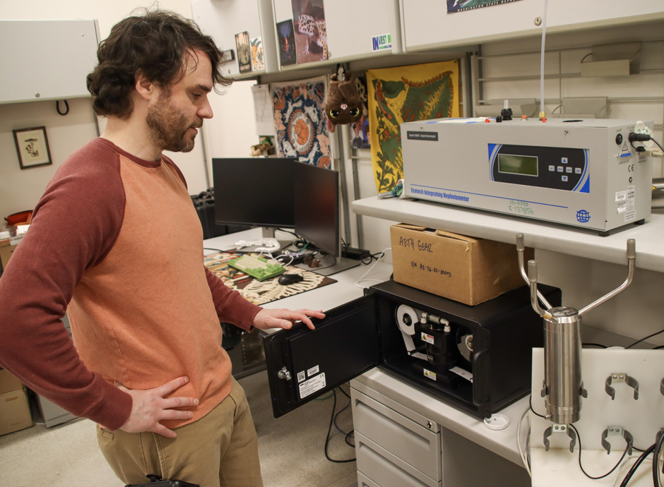 Ecology's Wes Davis examines an aethalometer, used to measure black carbon.